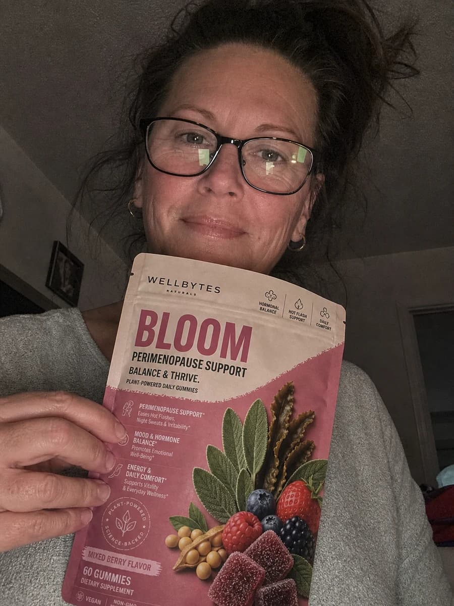 Customer-style selfie holding a WellBytes Bloom pouch